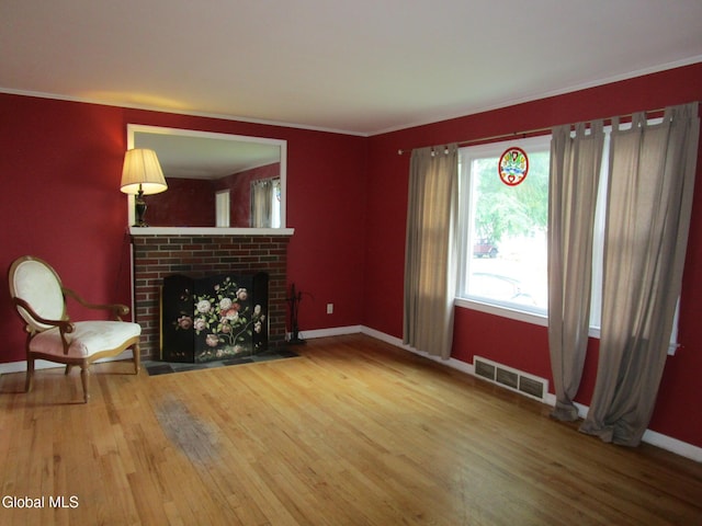 16 Knickerbocker Rd, Scotia, NY 12302 - unfurnished living room with wood finished floors, a fireplace, and crown molding