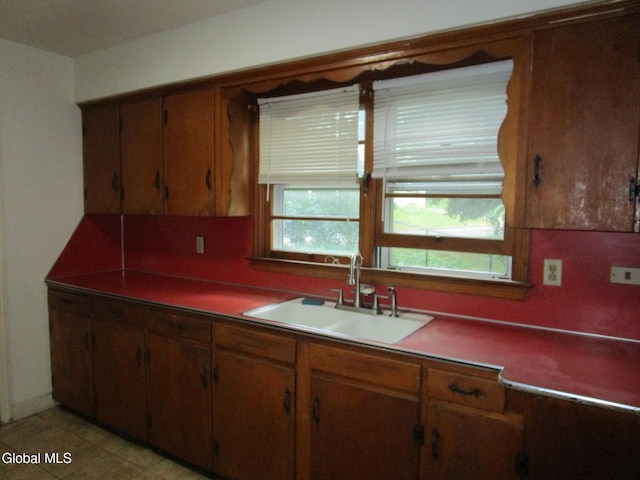 16 Knickerbocker Rd, Scotia, NY 12302 - kitchen featuring tasteful backsplash, brown cabinetry, and light tile patterned floors