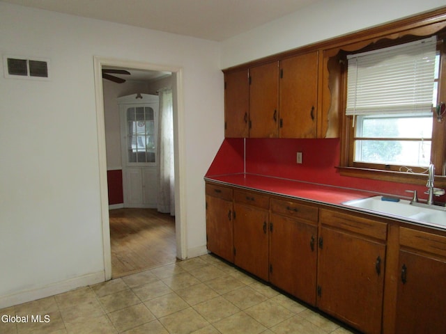 16 Knickerbocker Rd, Scotia, NY 12302 - kitchen with a ceiling fan, brown cabinetry, and light tile patterned floors