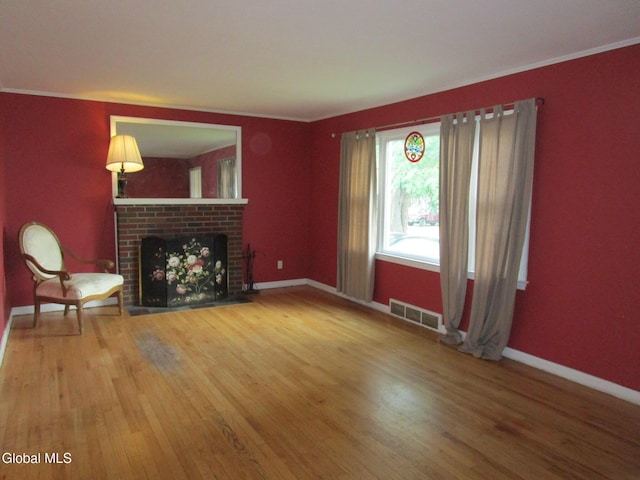 16 Knickerbocker Rd, Scotia, NY 12302 - unfurnished living room featuring wood finished floors, a fireplace, and ornamental molding