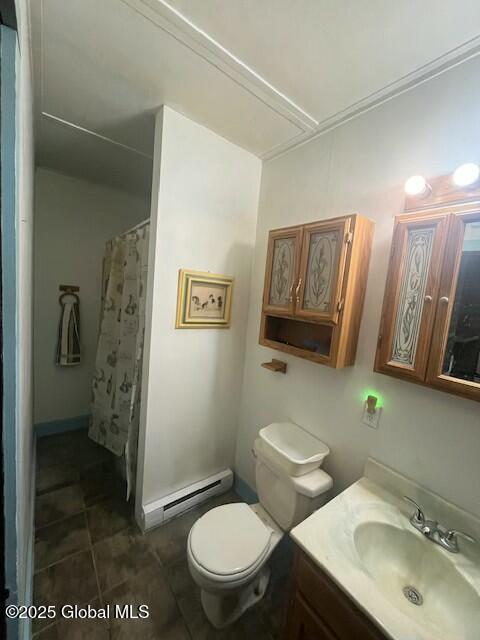 bathroom featuring a shower with curtain, toilet, vanity, tile patterned floors, and a baseboard heating unit