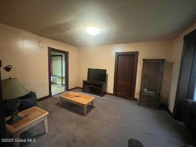 carpeted living room with baseboards