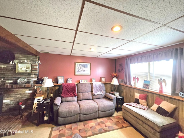 living area featuring a paneled ceiling