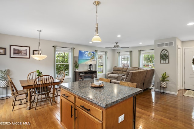 9 Barton Ave, Fort Edward, NY 12828 - kitchen featuring light wood-style flooring, dark countertops, healthy amount of natural light, a center island, and recessed lighting