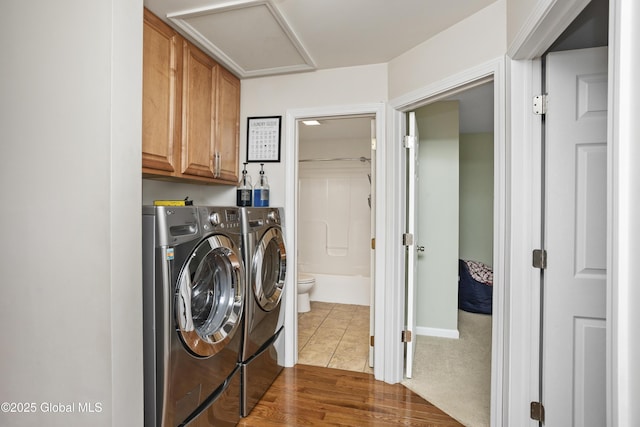 9 Barton Ave, Fort Edward, NY 12828 - laundry area with washer and clothes dryer, attic access, cabinet space, and dark wood-type flooring