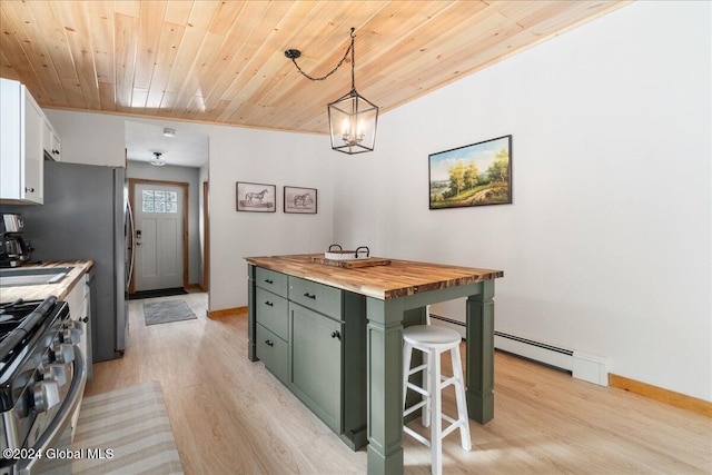 kitchen featuring wooden ceiling, wooden counters, light wood-style floors, stainless steel range with gas cooktop, and green cabinets