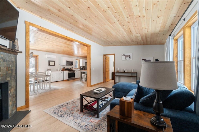 living room featuring wood ceiling, a fireplace, and a wealth of natural light