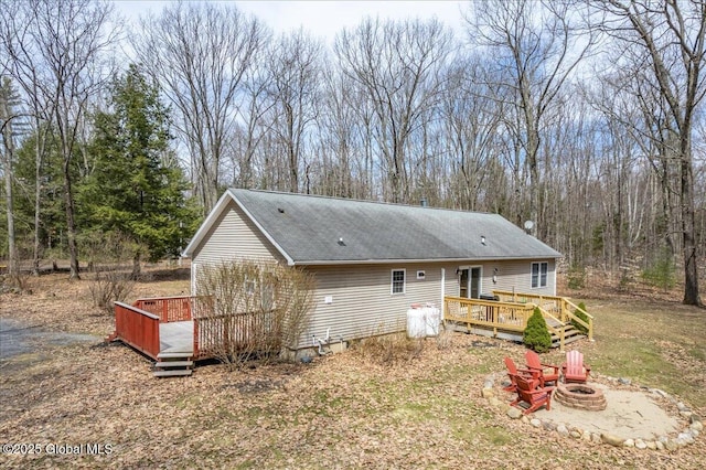 exterior space with a deck and an outdoor fire pit