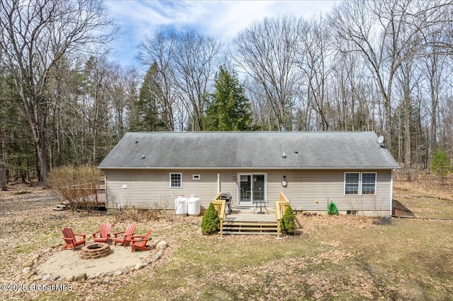 rear view of house featuring an outdoor fire pit and a deck