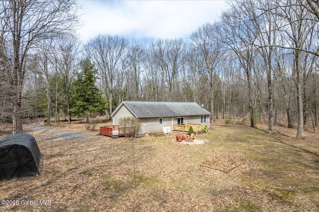 view of yard with a view of trees and a deck