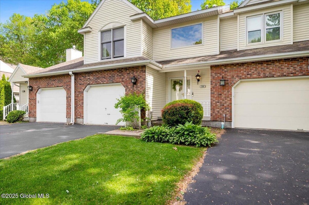38 Woodside Dr, Clifton Park, NY 12065 - view of front of home with driveway, brick siding, an attached garage, a front lawn, and a chimney