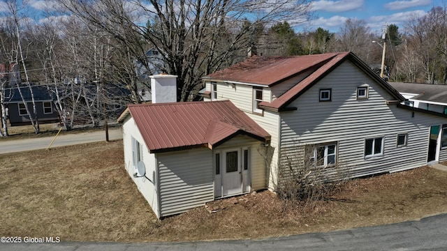 view of side of home with metal roof