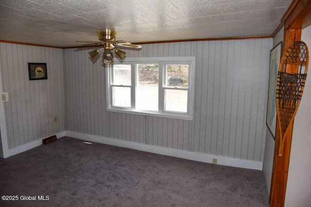 carpeted spare room with baseboards and a ceiling fan