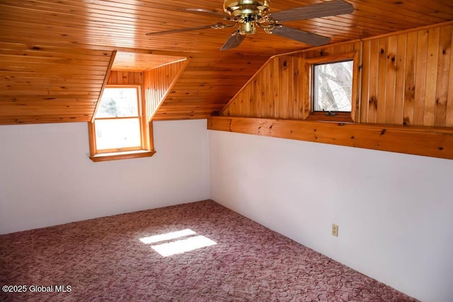 additional living space featuring ceiling fan, plenty of natural light, carpet, and wood ceiling