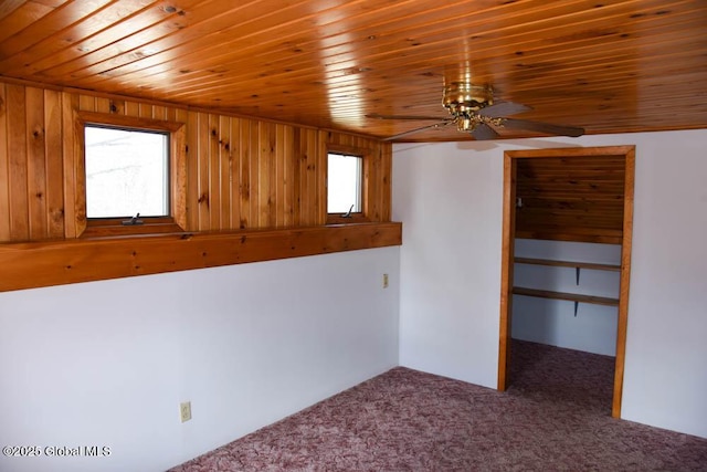 interior space with wood ceiling, multiple windows, and carpet floors