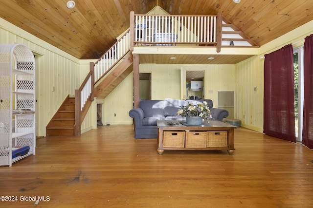 living area with high vaulted ceiling, stairway, wooden ceiling, and wood finished floors