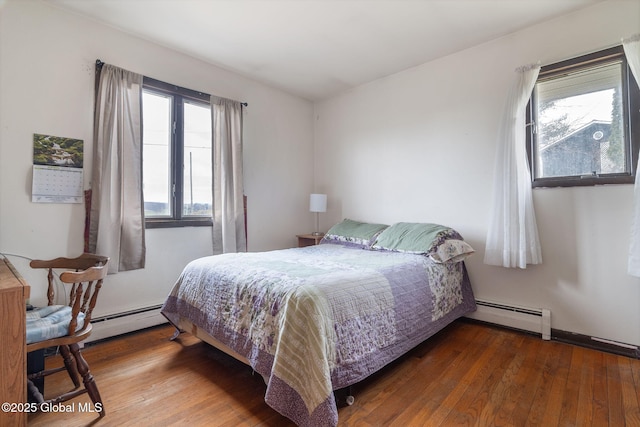 bedroom featuring wood-type flooring and a baseboard radiator