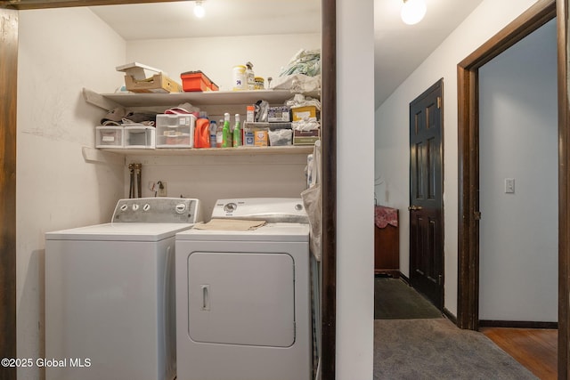 washroom featuring separate washer and dryer, laundry area, and wood finished floors