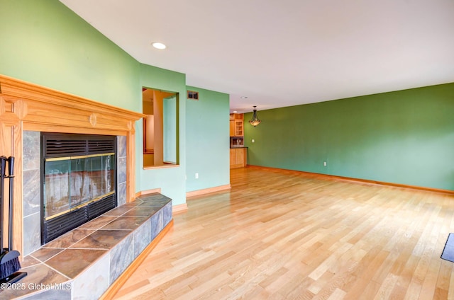 132 County Highway 152 Unit C, Northville, NY 12134 - unfurnished living room featuring a fireplace, wood finished floors, and recessed lighting