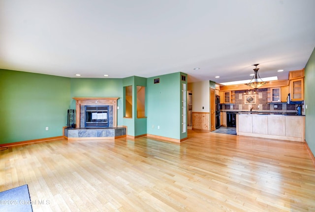 132 County Highway 152 Unit C, Northville, NY 12134 - unfurnished living room with light wood-style flooring, a high end fireplace, and recessed lighting