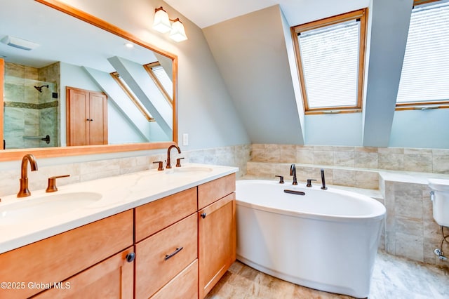 132 County Highway 152 Unit C, Northville, NY 12134 - bathroom featuring tile walls, a soaking tub, double vanity, a stall shower, and vaulted ceiling