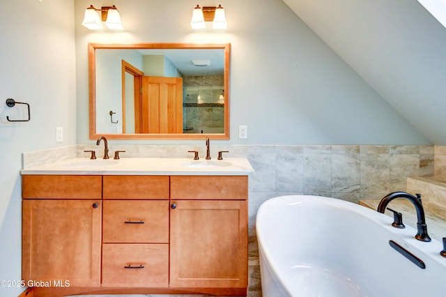 132 County Highway 152 Unit C, Northville, NY 12134 - bathroom with a soaking tub, double vanity, a stall shower, lofted ceiling, and tile walls