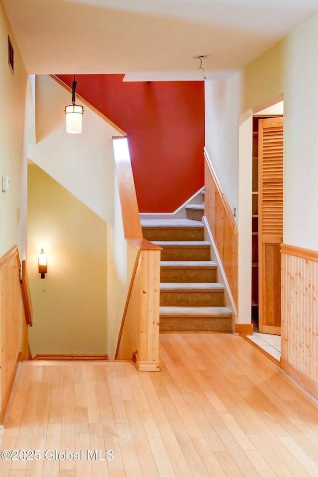 132 County Highway 152 Unit C, Northville, NY 12134 - stairway featuring wainscoting, wood finished floors, and wooden walls