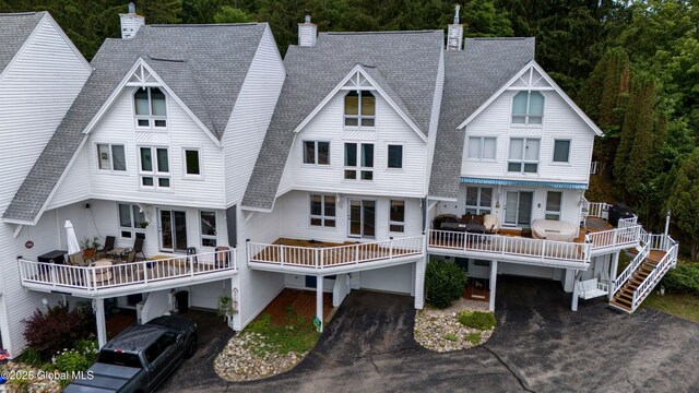 132 County Highway 152 Unit C, Northville, NY 12134 - rear view of house with a chimney, roof with shingles, a forest view, and asphalt driveway