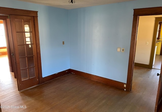 empty room featuring baseboards and wood finished floors