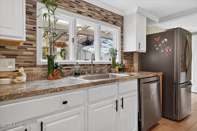 458 Central Ave, Niskayuna, NY 12304 - kitchen featuring stainless steel appliances, a sink, decorative backsplash, white cabinetry, and ornamental molding
