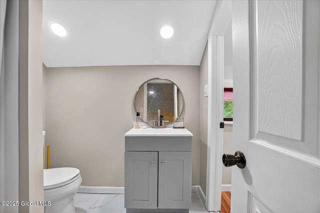 458 Central Ave, Niskayuna, NY 12304 - bathroom with baseboards, vanity, toilet, and marble finish flooring