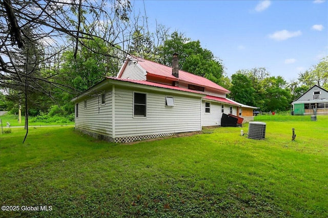 458 Central Ave, Niskayuna, NY 12304 - back of property featuring cooling unit, a yard, and metal roof