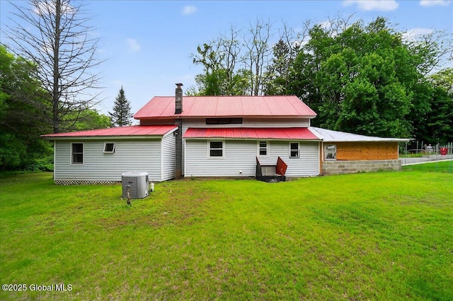 458 Central Ave, Niskayuna, NY 12304 - rear view of house featuring metal roof, a yard, and cooling unit