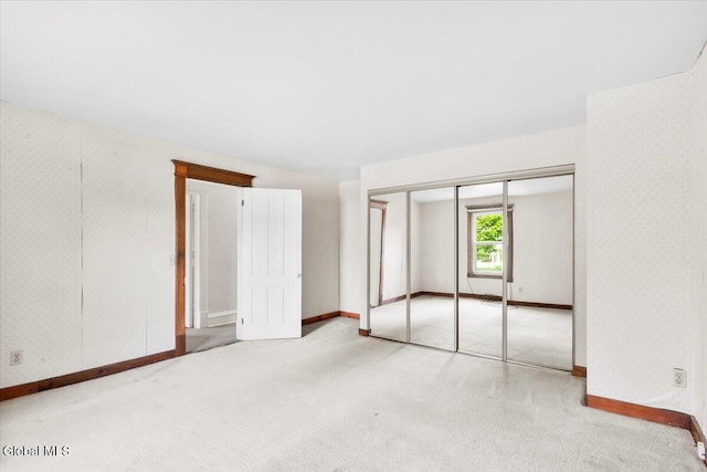 104 Euclid Ave, Altamont, NY 12009 - unfurnished bedroom with wallpapered walls, carpet, and a closet