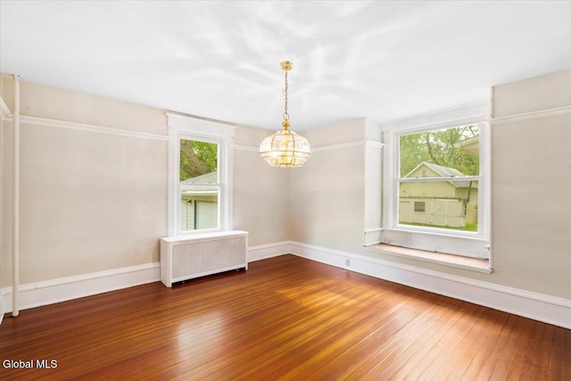 104 Euclid Ave, Altamont, NY 12009 - empty room featuring radiator heating unit, a chandelier, wood-type flooring, and healthy amount of natural light