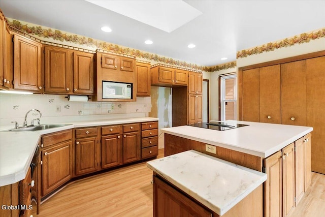 104 Euclid Ave, Altamont, NY 12009 - kitchen featuring white microwave, light wood-type flooring, brown cabinets, and recessed lighting