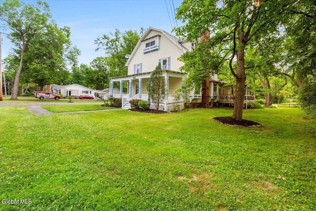 104 Euclid Ave, Altamont, NY 12009 - view of front facade featuring a porch, a gambrel roof, a front lawn, and a chimney