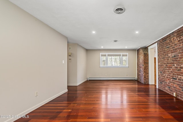 unfurnished room with baseboard heating, baseboards, wood-type flooring, brick wall, and recessed lighting