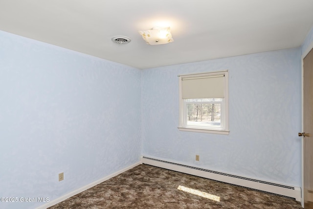 carpeted spare room with baseboards, visible vents, and a baseboard radiator