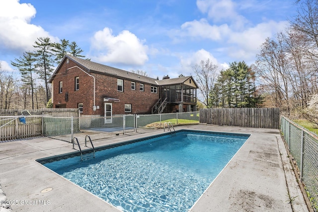 view of swimming pool with fence, a patio area, a fenced in pool, and stairs
