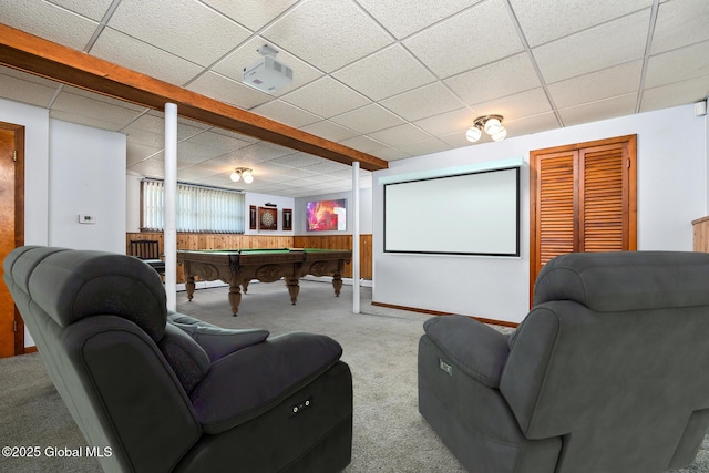 home theater room with wooden walls, carpet floors, pool table, and a drop ceiling