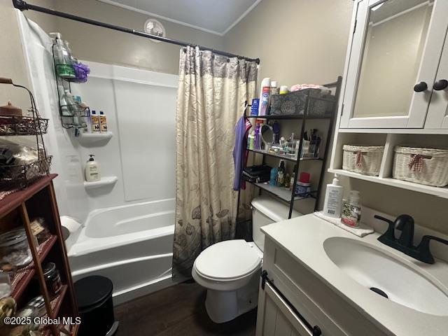 2543 Moriah Rd, Moriah, NY 12960 - full bathroom featuring shower / tub combo with curtain, vanity, toilet, and wood finished floors