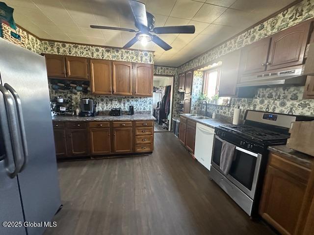 2543 Moriah Rd, Moriah, NY 12960 - kitchen featuring dark wood-style flooring, under cabinet range hood, ceiling fan, stainless steel appliances, and a sink