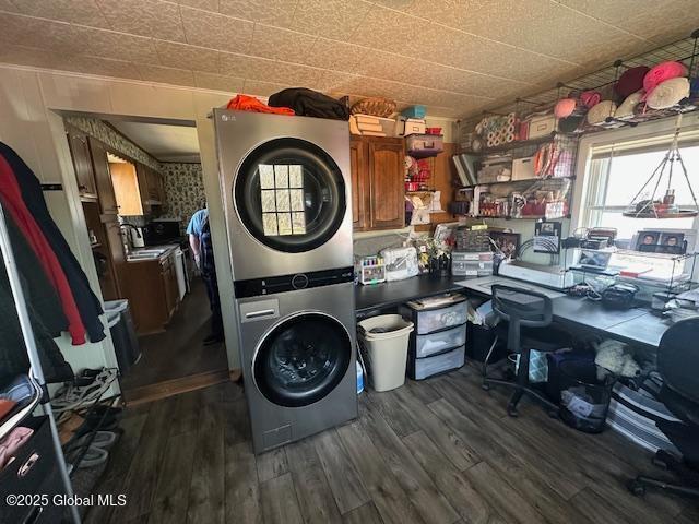 2543 Moriah Rd, Moriah, NY 12960 - washroom featuring dark wood-type flooring and stacked washer / dryer