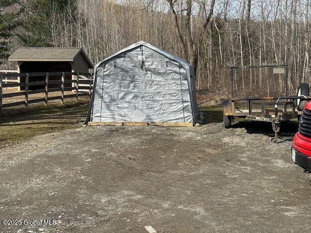 2543 Moriah Rd, Moriah, NY 12960 - garage featuring a storage shed and fence