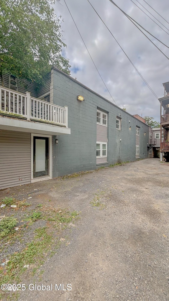 view of side of home featuring concrete block siding