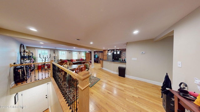 living room with recessed lighting, light wood-type flooring, and baseboards