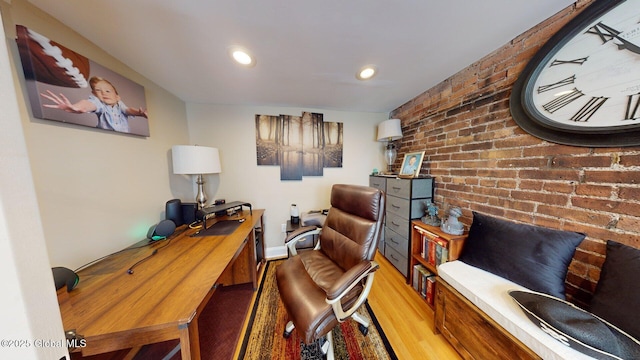 home office featuring recessed lighting, wood finished floors, and brick wall