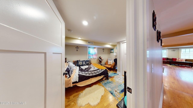 bedroom with visible vents and wood finished floors