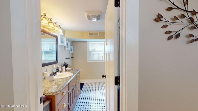 bathroom with visible vents, tile patterned floors, vanity, and baseboards
